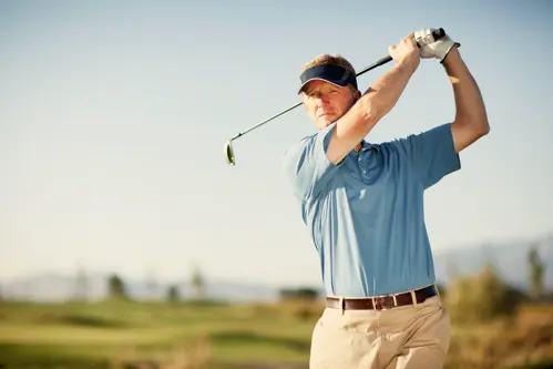 golfer swinging their club on a golf course